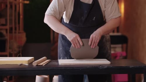 Person shaping clay in pottery workshop