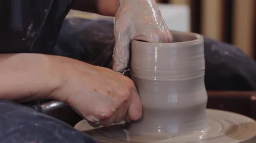 Pottery Pulling Up a Piece of Clay on a Pottery Wheel