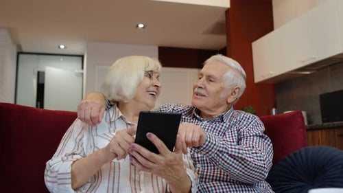 Affectionate Senior Couple Using Tablet at Home