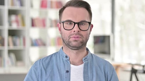 Man With Glasses Looking at Camera, Close Up