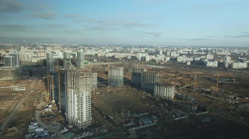 Aerial View of City and Building Construction Site