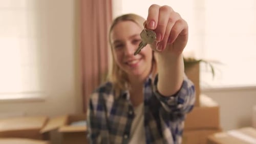 Young Woman Showing Keys to New Home