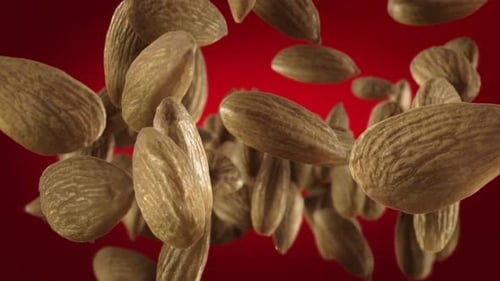 Dynamic Falling Almonds on Red Background