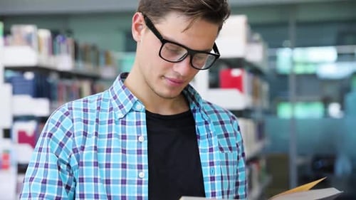 Bookstore. Man Student Reading Books Near Bookshelves