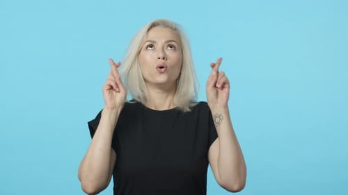 Woman Crossing Fingers and Making a Wish