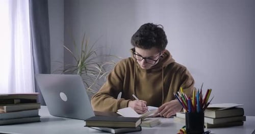 Young Adult Studying at a Table