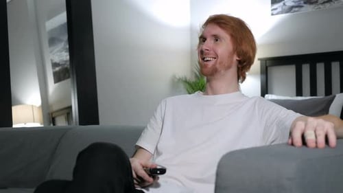 Young Adult Man Watching Television at Home