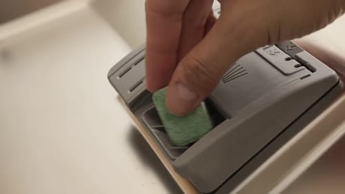 Slow motion dishwasher tablet putting in automatic tray 1080p FullHD footage - Close-up dishware and