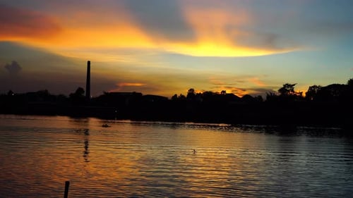 Golden Sunrise Reflecting on Calm River Water