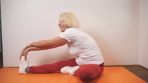 Senior Woman Stretching Her Legs at Home