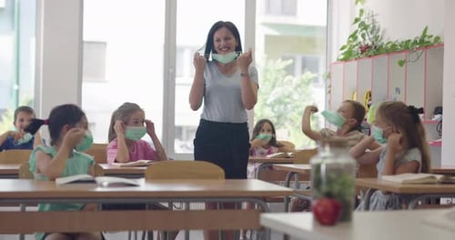 Teacher And Students Remove Face Masks In Classroom