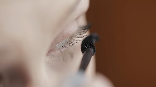 Applying Black Mascara to Eyelashes in Macro Detail