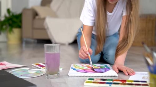 Young Girl Painting With Watercolors at Home