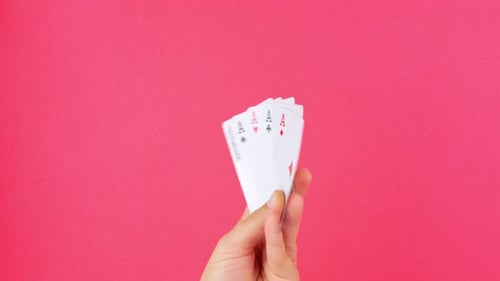 Hand displaying royal flush poker cards