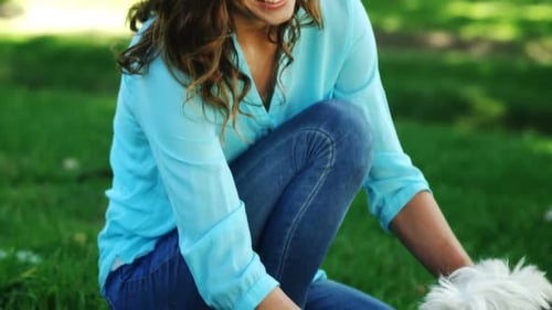 Woman playing with her dog in the park