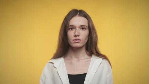 Young Woman with Brown Hair Looking at Camera