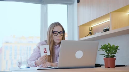 Woman Teaching Alphabet with Laptop and Flashcards