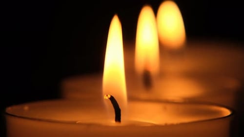 Candles close-up set on black background.Candle flame.