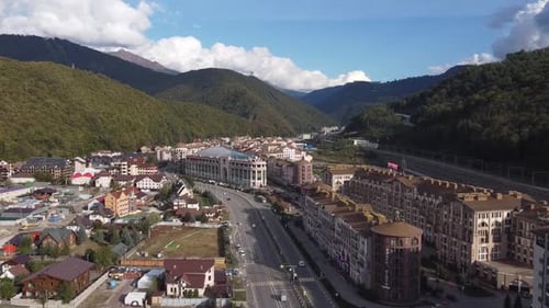 Aerial View of Town Amongst Green Mountains