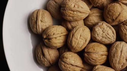 Pile of Walnuts in White Bowl, Close Up