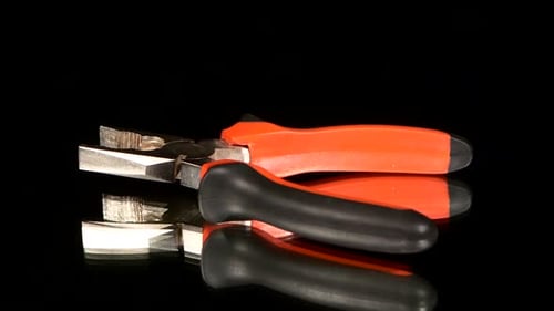 Metal Pliers with Red Handles Close Up