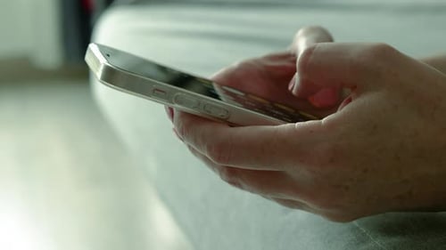 Hands Using Smartphone Indoors Close-up