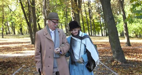 Happy Elderly Married Couple Walking Together Holding Hands and Having Fun
