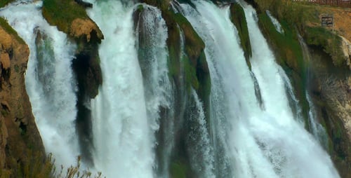 Beautiful Waterfall Flowing Down Rocky Cliffside