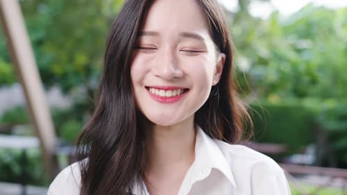 Woman Puts on Protective Mask Outdoors