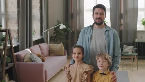 Father Poses with Son and Daughter Indoors