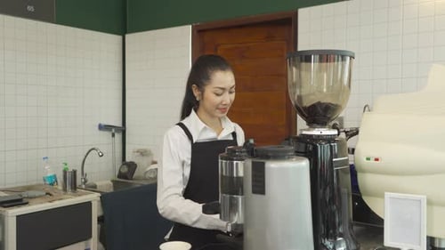 Young Woman Barista Preparing Coffee in a Cafe