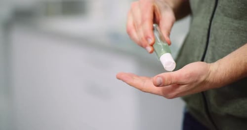 Man Disinfecting Hands with Antibacterial Gel