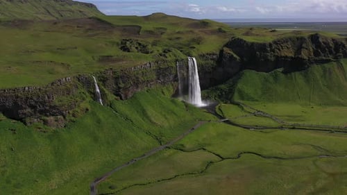 Aerial View of Waterfalls Flowing Through Green Landscape