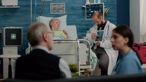 Doctor Consults with Elderly Patient in Hospital Room