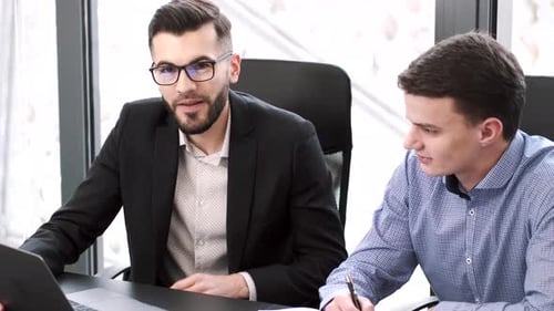 Collegues Working with Laptop at Modern Office