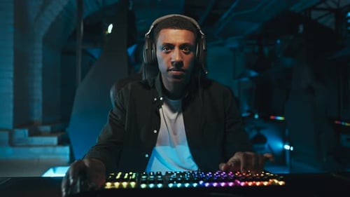 Young Adult Playing on Gaming Computer at Night