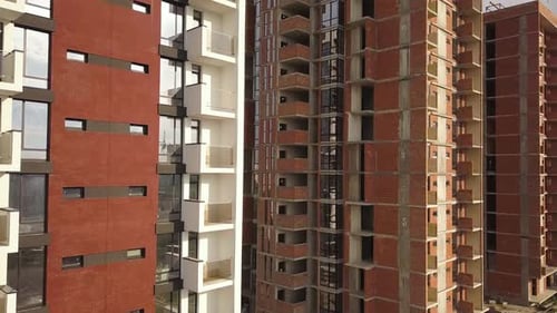 Aerial view of tall residential apartment buildings under construction. Real estate development.