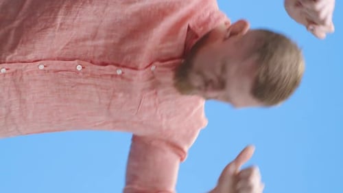 Man with Blond Hair Dancing Upward Facing Camera