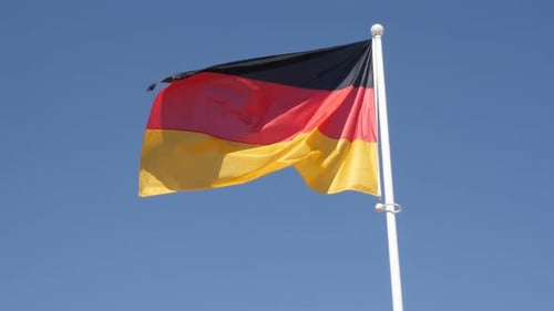 German Flag Waving in Clear Blue Sky