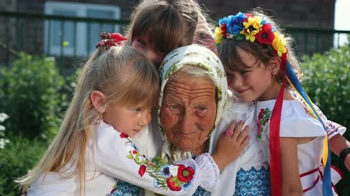 An Old Grandmother is Sitting on the Street and Reading a Book