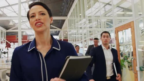 Business Professionals Walking Through Modern Office Space