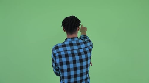 Rear View of Young African Hipster Man Directing and Pointing Finger