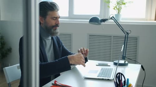 Man with Grey Hair Working at Desk