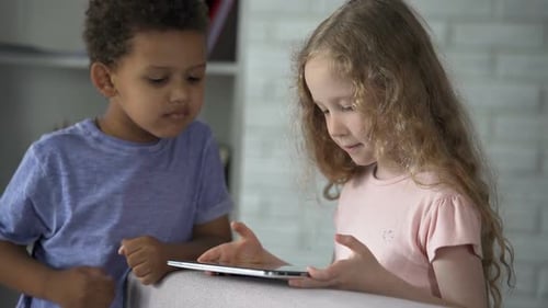 Children Using Tablet Together Indoors