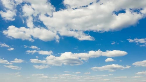 White Clouds Float Across a Blue Sky