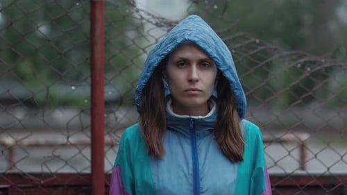 Young Woman Wearing a Hooded Jacket in the Rain