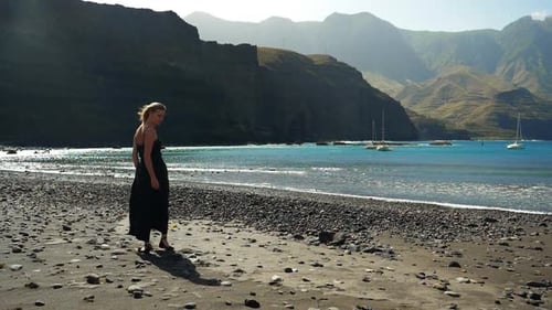 Woman in Dress on Rocky Ocean Beach
