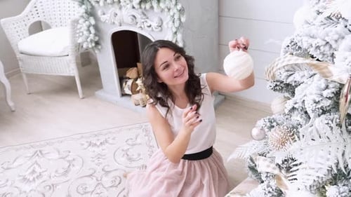 Woman Decorating Christmas Tree at Home