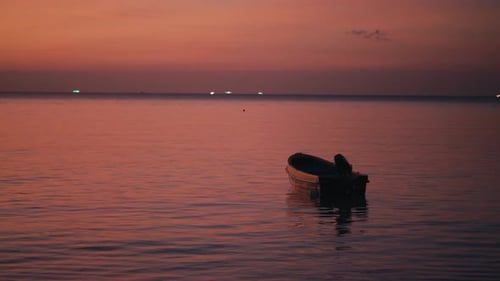 Boat on Calm Ocean at Sunset