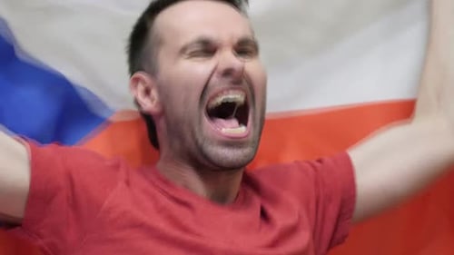 Man Yelling in Front of a Flag